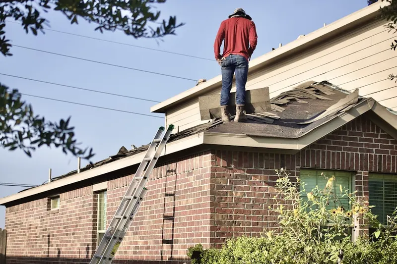 Professional roofer working on a residential roof in Skytop